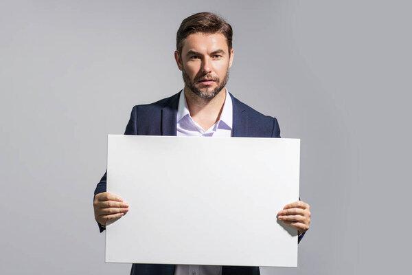 男人拿着标牌空白卡片为您的产品准备好了贴纸。在你的文字上签名。在独立的工作室背景上显示空白标牌的人.空白板。广告面积、复制空间