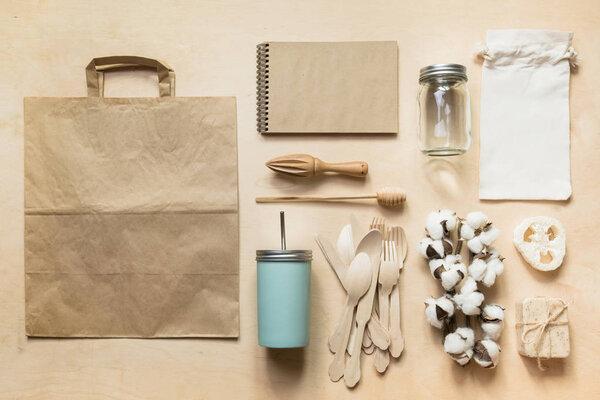 Zero waste concept. Wooden utensils, reusable paper bag, natural cotton materials.