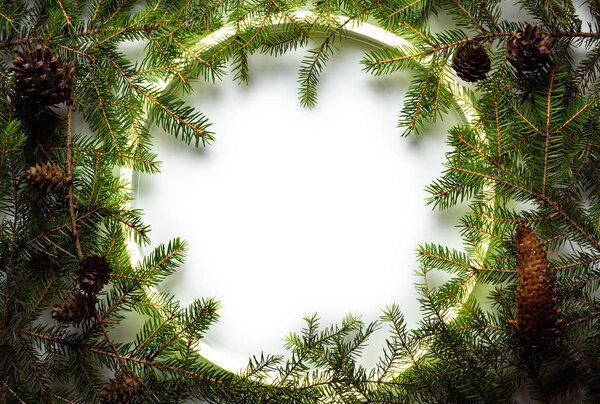 Christmas round frame made by neon and winter things on white background.