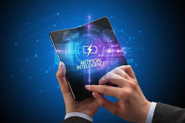 Businessman holding a foldable smartphone, technology concept