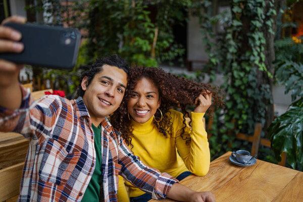 Young couple outdoors taking a selfie. 
