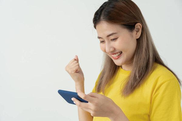 excited young woman play games by mobile phone make winner gesture. female winning mobile gambling. Wow face expression. Esport streaming game online, surprise, gamer, online, earning, new generation.