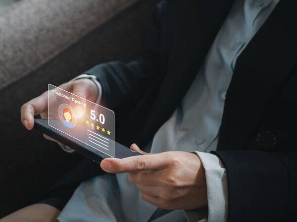Customer review, satisfaction, feedback, survey concepts. The User giving 5 stars point rating with smile face icon to service experience, business ranking on online application by smart mobile phone.