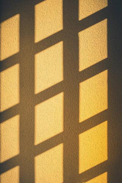 Abstract window shadows on the yellow wall. 