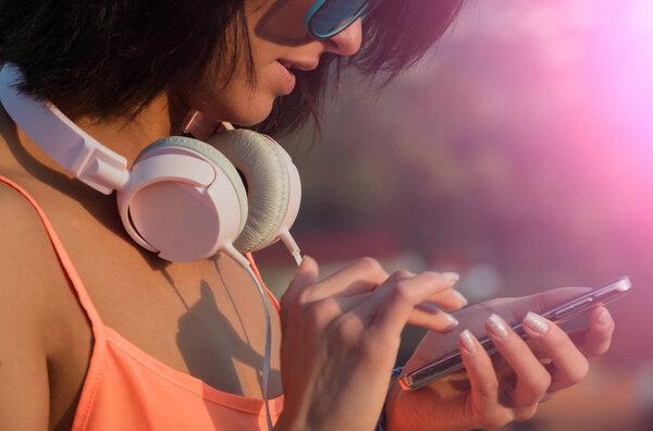 Pretty girl texting on smartphone with touchscreen