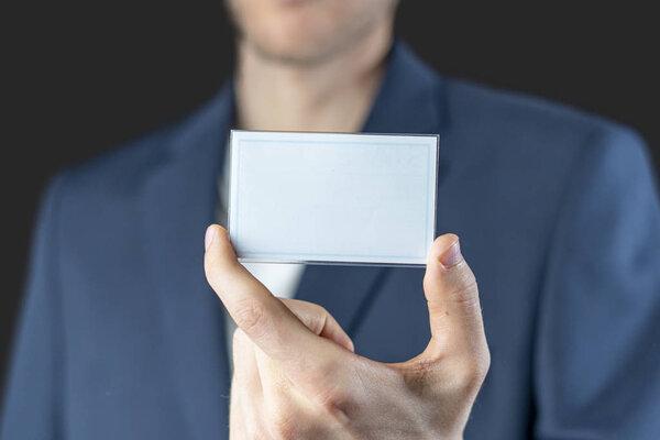 businessman holding an empty badge with copy space mockup, authorization and identification
