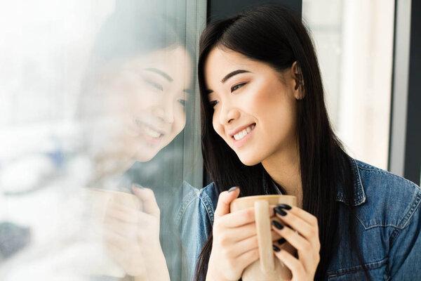 asian woman drinking coffee