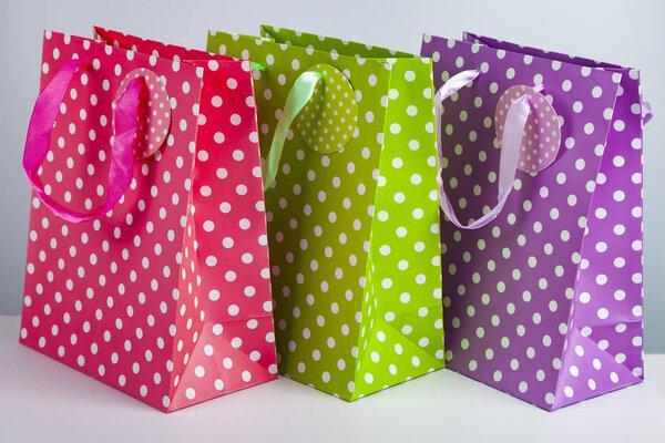 Three multi-colored shopping bags 