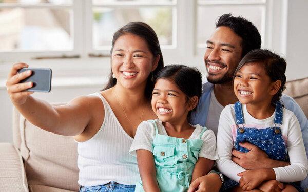 Selfie, happy and mom, dad and children on sofa for social media, profile picture and online post. Family, love and mother, father and kids take photo for bonding, weekend and relax in living room.