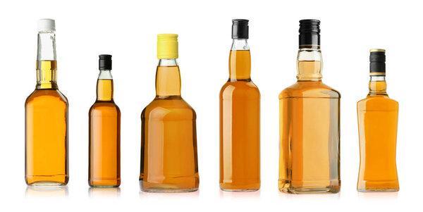 Many bottles of whiskey isolated on white, set
