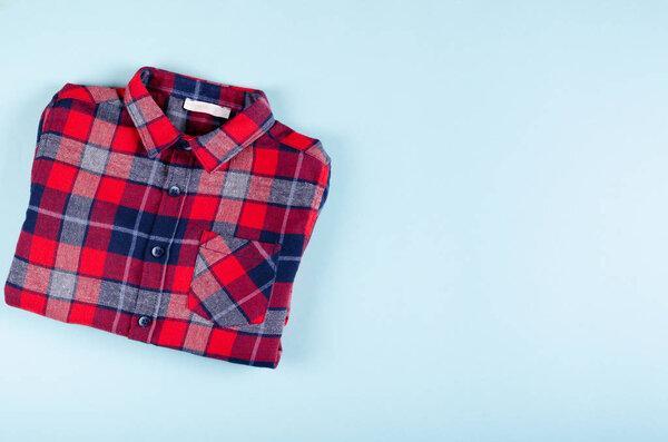 Textile, shirt composition on color background. Flat lay.