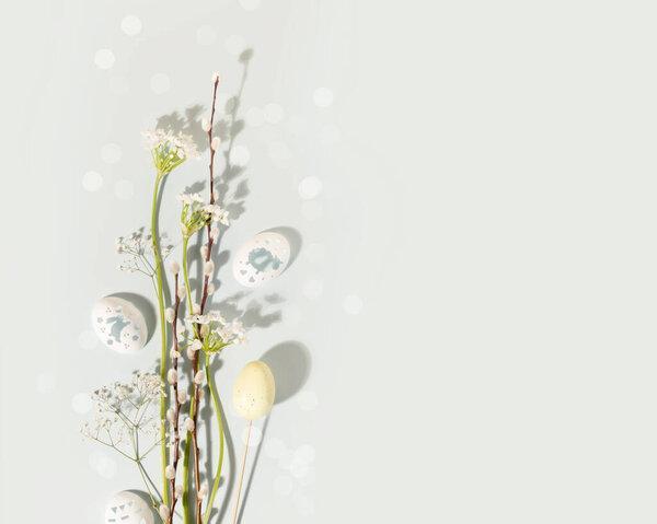 Easter bouquet with white flowers, willow twigs and decorative eggs