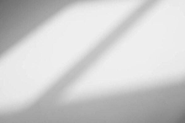 Abstract light reflection and grey shadow from window on white wall background. Gray window shadows and sunshine stripe diagonal geometric overlay effect for backdrop and mockup desig