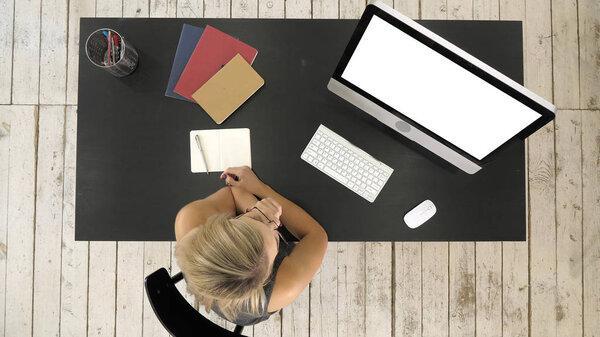 Girl watching on screen of computer. White Display.