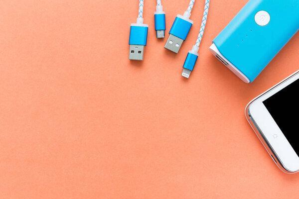 USB charging cables for smartphone and tablet in top view on ora