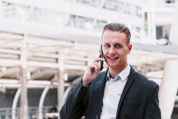 Handsome businessman using his smartphone