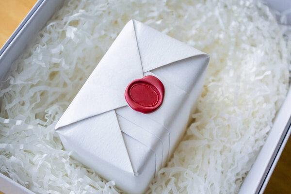 Wax seal stamp on white paper wrap packaging parcel box