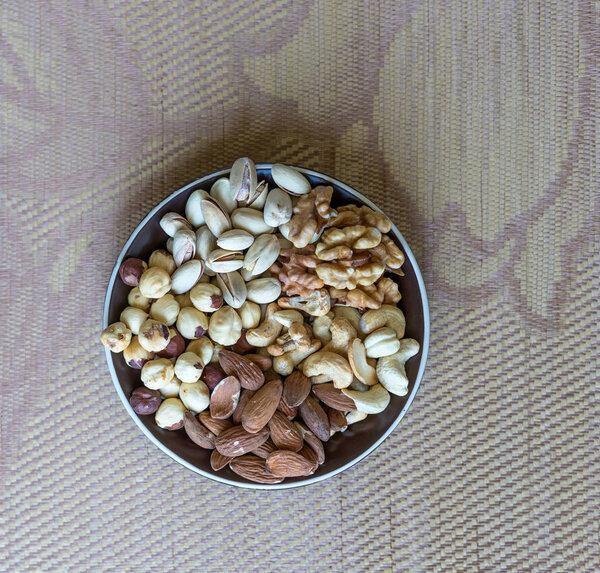 Healthy food. Nuts mix assortment on stone texture top view. Collection of different legumes for background image close up nuts, pistachios, almond, cashew nuts, peanut, walnut. image