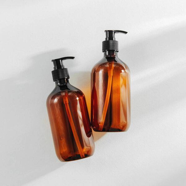 Transparent brown Bottles for Shampoo, Soap or other cosmetic on white background