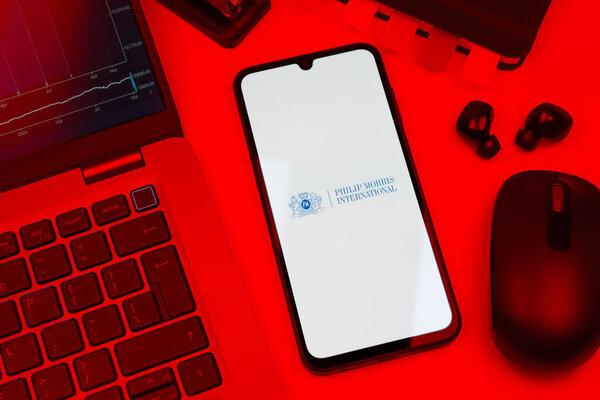 Prague, Czechia - 10 21 2024: Smartphone on surface showing Philip Morris logo.