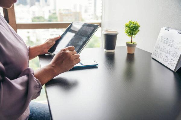 Close up Woman Hands Using Smartphone Shopping online at office desk. Woman touch screen holding smartphone open website social. Online Shopping Website on Laptop. Easy Website Shop by cellphone
