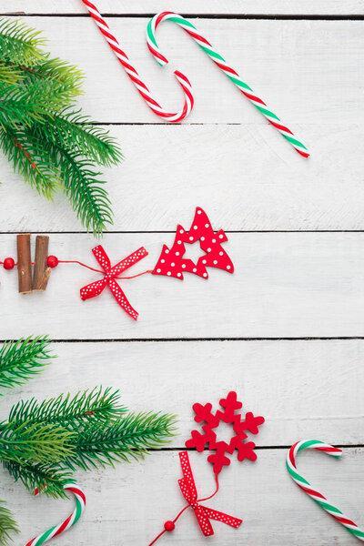Candy canes flat lay on white wooden background. Christmas and New Year decoration.