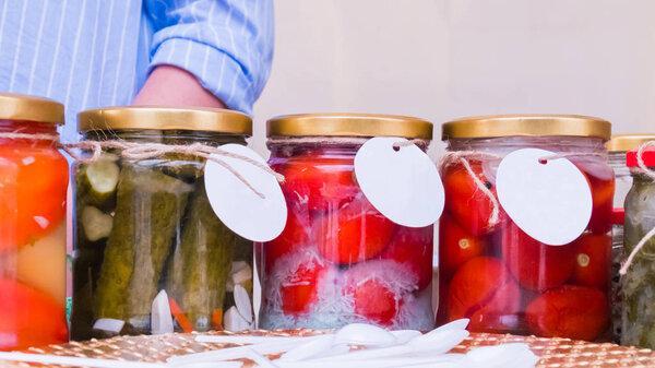 Homemade pickled tomatos and cucumbers jars