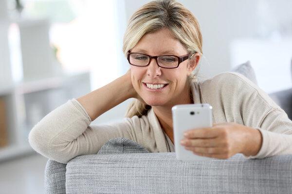 Woman reading text message on phone