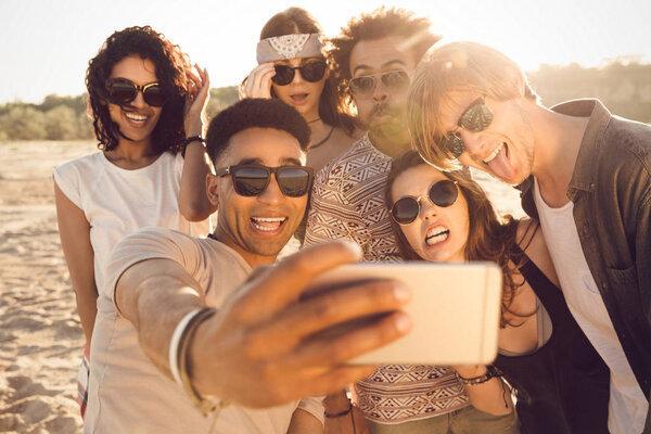 Multiracial group of friends taking selfie