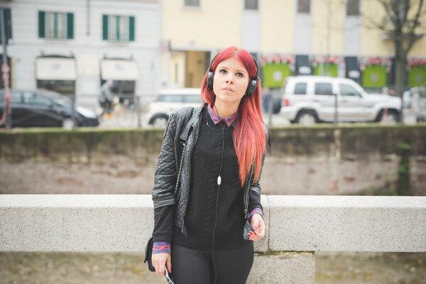 young beautiful red hair venezuelan woman lifestyle listening mu