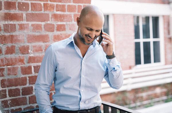 In business, connectivity is king. a mature businessman using a smartphone outside of a modern office