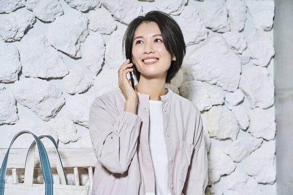 Smiling woman talking on smartphone