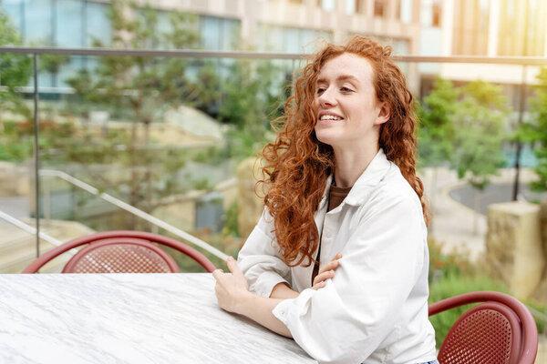 woman having coffee at the street cafe outside, talking on the phone and having fun time. lifestyle concept