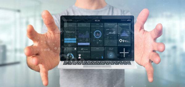 Businessman holding Laptop with business user interface data on 