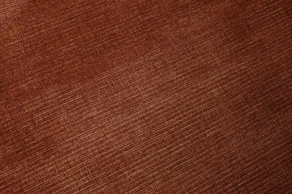 Textured corduroy furniture fabric in brown colors close-up