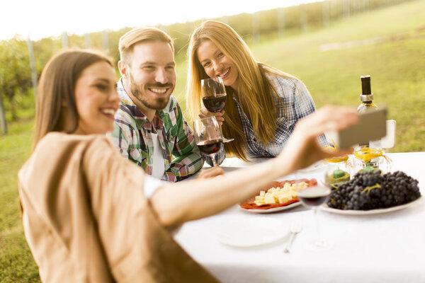 People enjoy dinner in vineyard