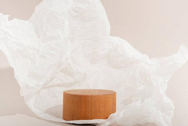 Real photo. Wooden Circle pedestal on pastel background Crumpled paper. Mockup for cosmetic, packaging product presentation, food or drink. Beauty podium.