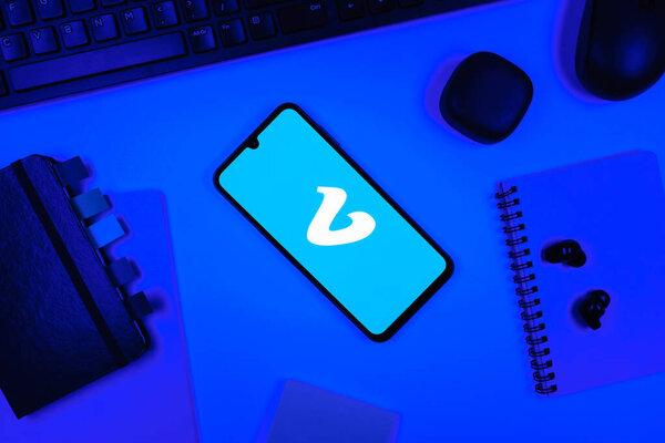 Prague, Czechia - 05 18 2025: Objects arranged on an office desk with a phone showing Vimeo logo.