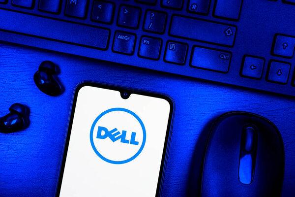 Prague, Czechia - 08 09 2025: A top-down view of a desk with a phone displaying the Dell logo. Dell is a technology company producing computers and IT solutions.
