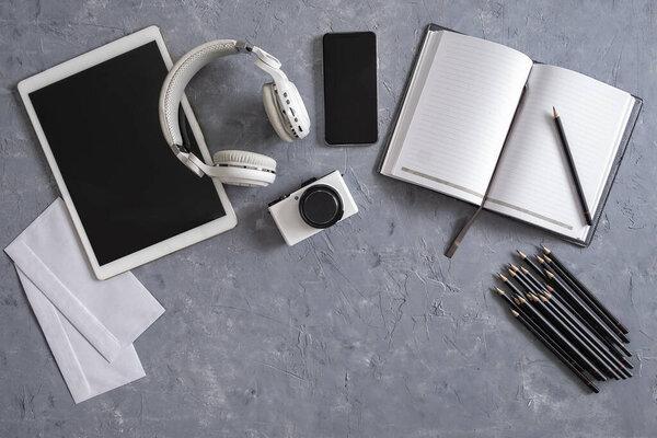 Directly above shot of office desk and stationery on gray background