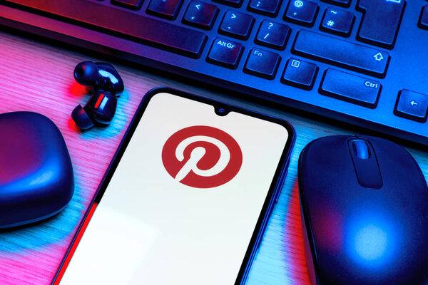 Prague, Czechia - 10 21 2024：Smartphone on surface showing Pinterest logo.