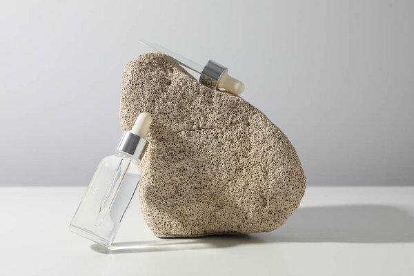 Cosmetic oil in a transparent bottle with a stone