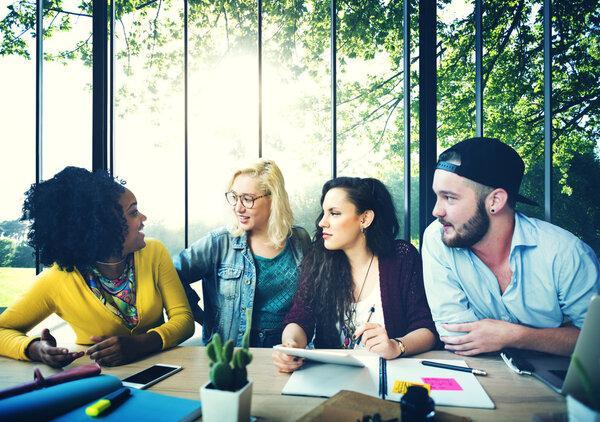 Diverse college students brainstorming in classroom
