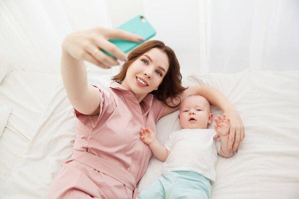 Mother and son selfie in the bedroom. top view