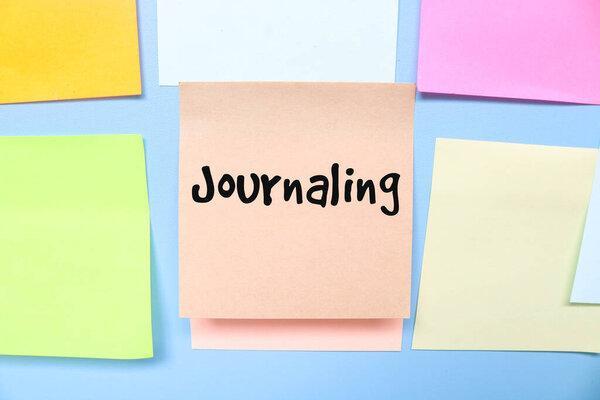 Journaling writing collection of sticky notes isolated on blue background. The concept of journaling and daily writing. Diary book for journaling