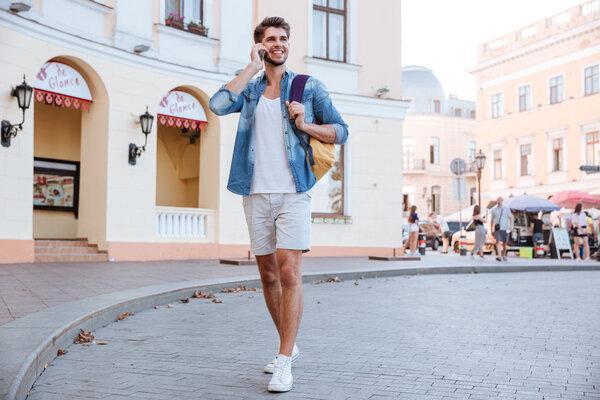 Man walking and talking on cell phone at the street