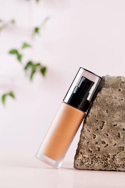 Face foundation in a glass dispenser. Layout. The concept of natural cosmetics.