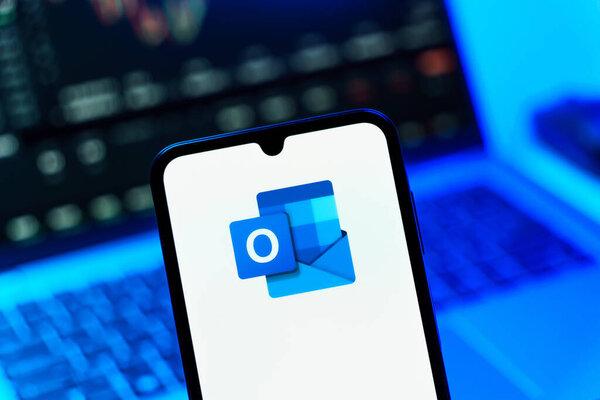 Prague, Czechia - 10 21 2024: Smartphone on surface showing Outlook logo.