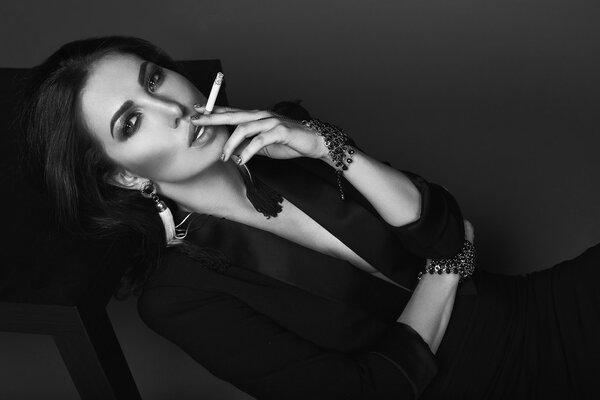 Elegant hot brunette woman smoking a cigarette