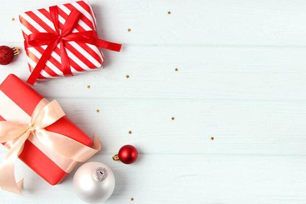 Christmas or New Year gifts on a colored background top view.